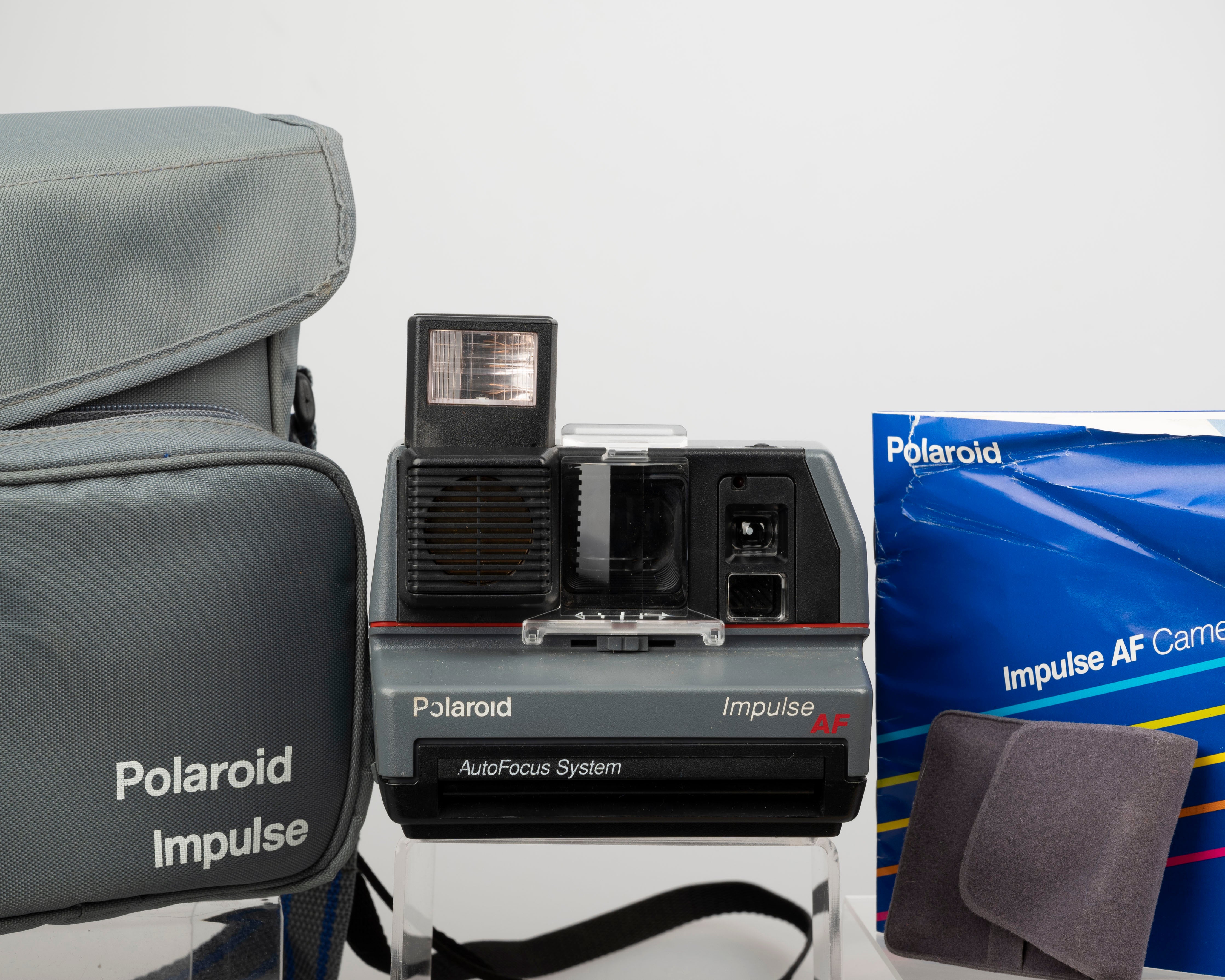Polaroid Impulse AF instant camera with original case, prism lens
